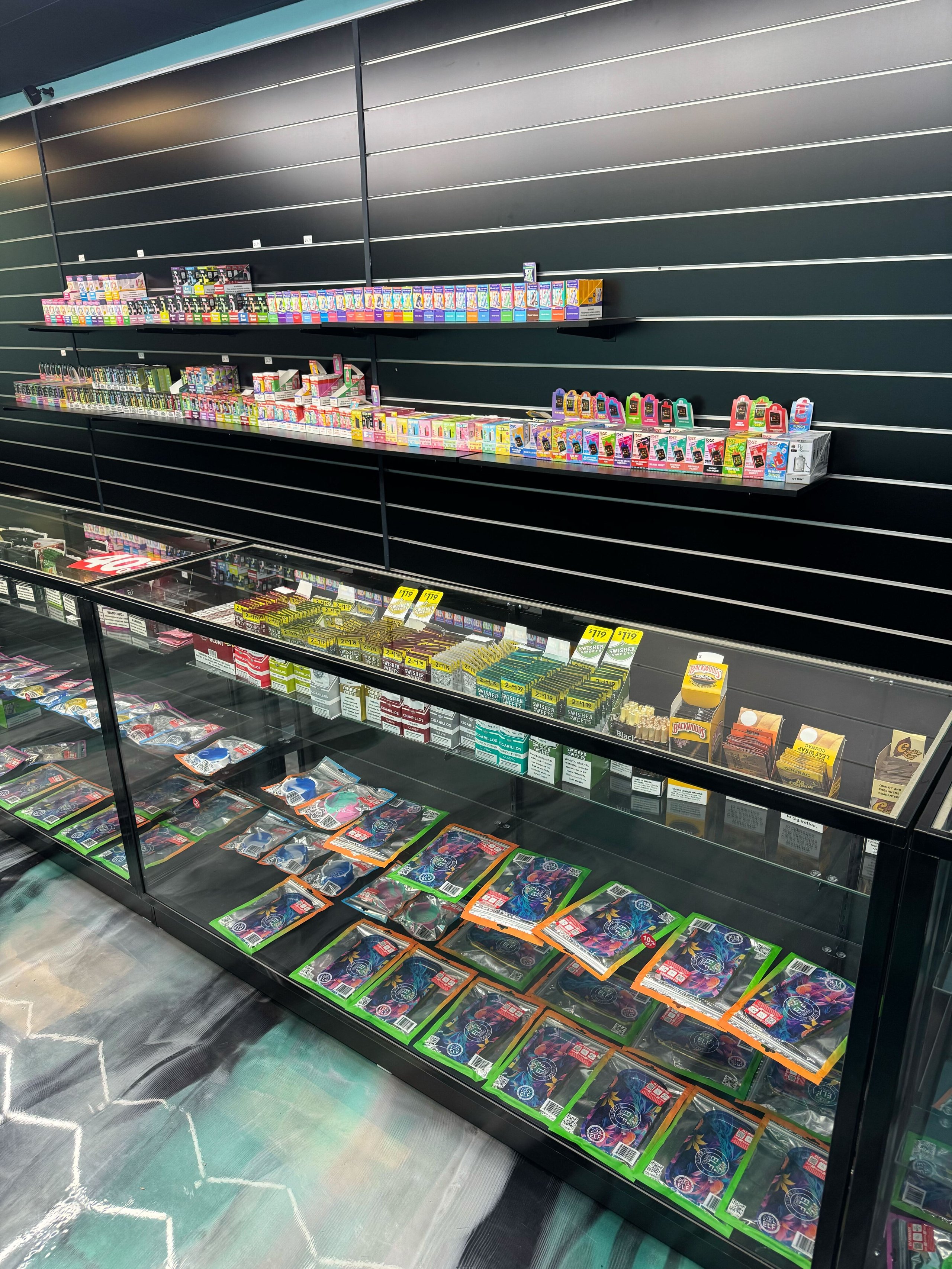 Retail display shelves with colorful trading cards, toys, and collectible items in glass cases